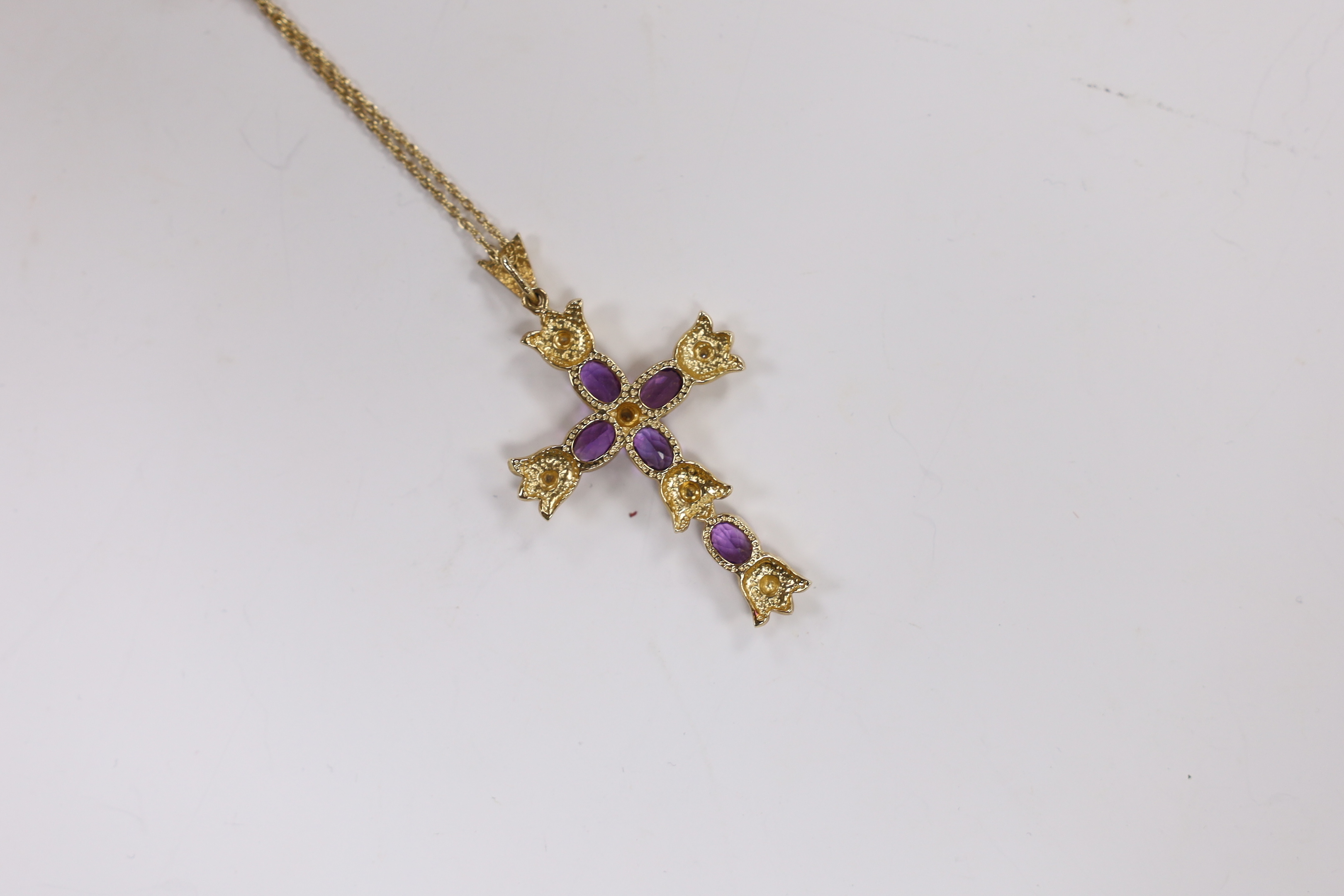 A modern 9k, amethyst and diamond cluster set cross pendant, 51mm, on a 585 yellow metal fine link chain, 45cm, gross weight 7.6 grams.